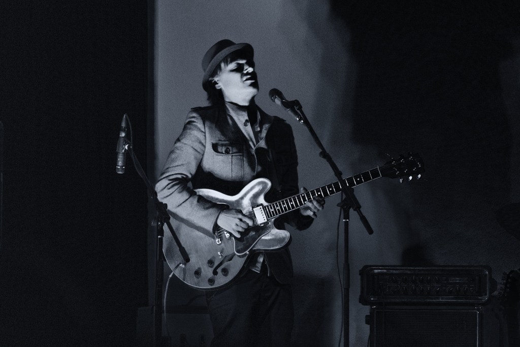 The Blues Guitar Spilling from an Open Window